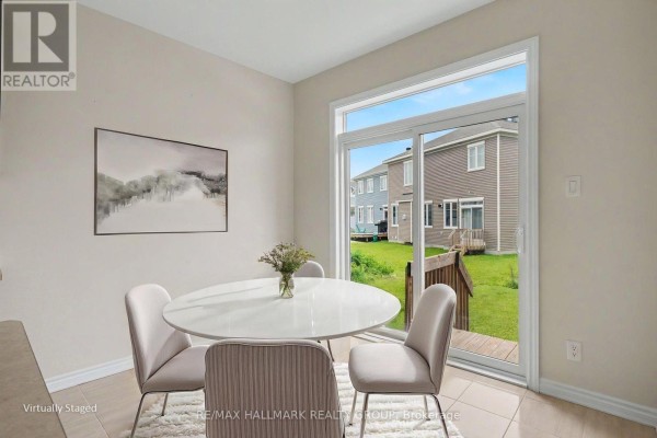 Dining area with oval table, chairs, and backyard view - 240 Sweetvalley Drive Ottawa
