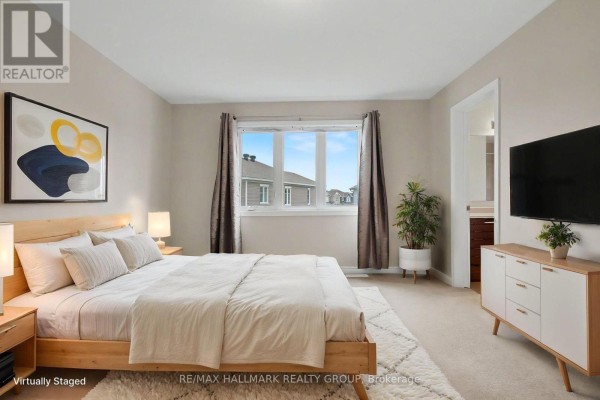 Bedroom with king size bed, modern dresser and large window - 240 Sweetvalley Drive Ottawa