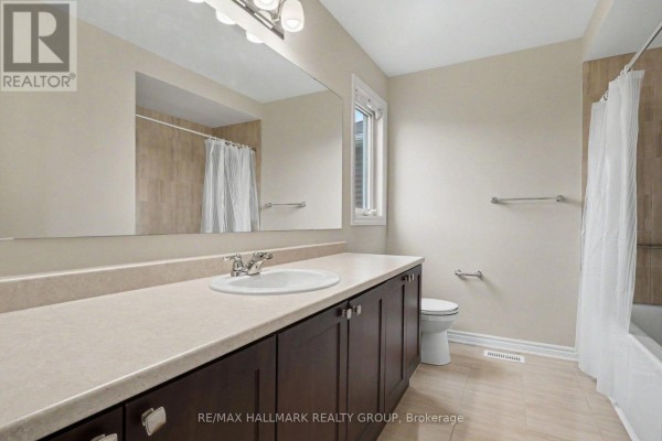 Bathroom with double vanity, beige tiles, and bathtub - 240 Sweetvalley Drive Ottawa