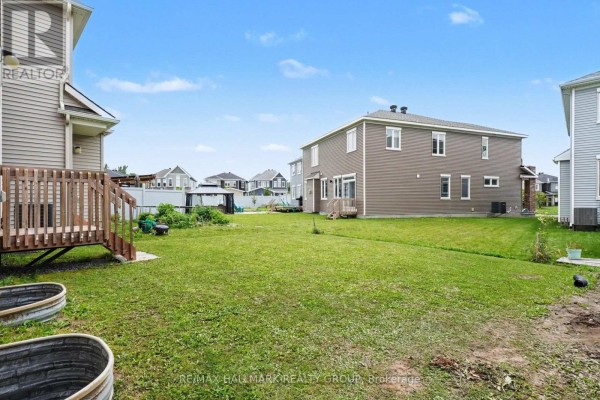 Backyard with wooden deck, gazebo, and metal planters - 240 Sweetvalley Drive Ottawa