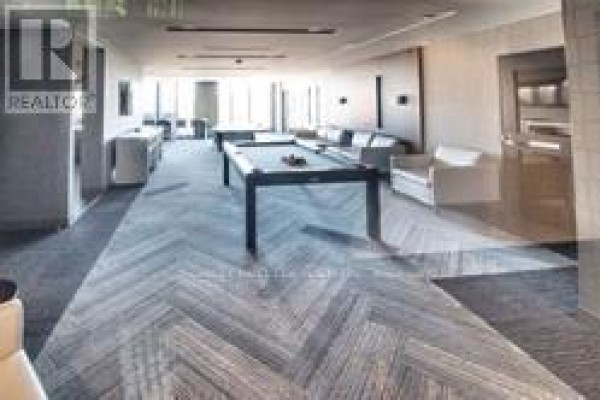 Games room with pool tables, lounge seating, and herringbone wood flooring. - 2401 - 51 East Liberty Street, Toronto
