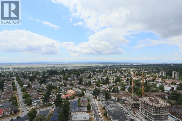 Panoramic aerial view of residential neighborhood and distant mountains. - 2401 6608 Sussex Avenue, Burnaby