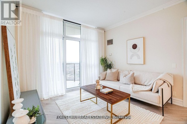 Living room with beige sofa, coffee table, sheer white curtains, and city view. - 2403 - 78 Harrison Garden Boulevard, Toronto