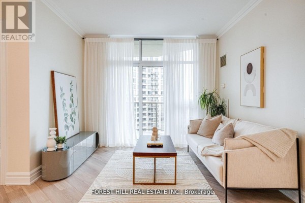 Living room with sofa, coffee table, art, sheer curtains, and city view from balcony. - 2403 - 78 Harrison Garden Boulevard, Toronto