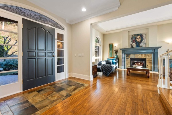 Front entrance interior with a dark gray door, decorative glass panels, and a slate tile entryway. - 2405 Cranberry Court, Abbotsford