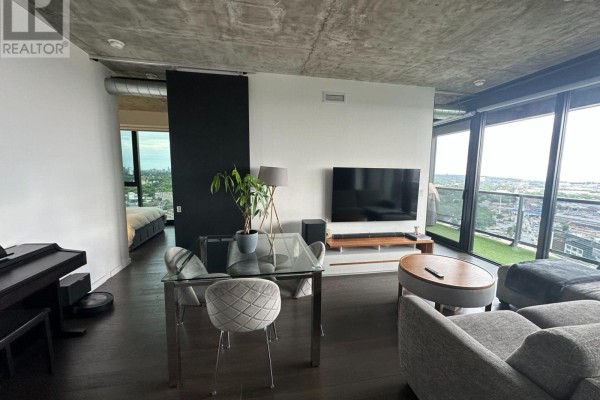 Apartment living space with open concept layout, sliding door to bedroom, and large windows with city view. - 2407 - 170 Bayview Avenue, Toronto