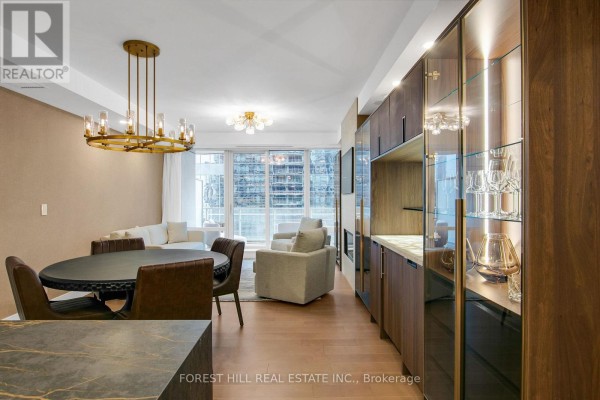 A dining area and living room with wood floors, contemporary furniture, and city views. - 2408 - 180 University Avenue, Toronto