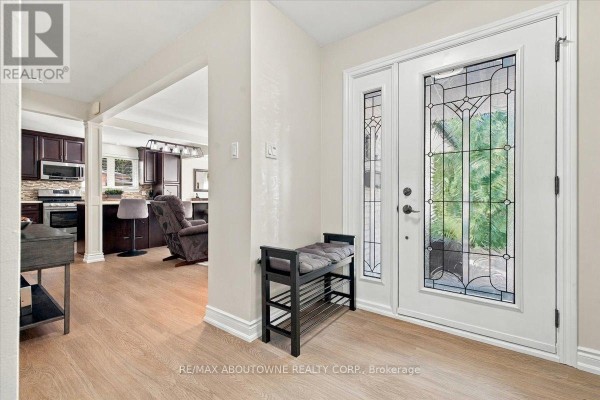 Interior view of a foyer with light wood floors and double glass doors. - 2408 Hereford Crescent, Burlington