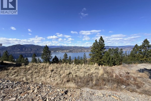 Lot with a paved driveway and a view of a lake and mountains in the distance. - 2409 Workman Place, Naramata