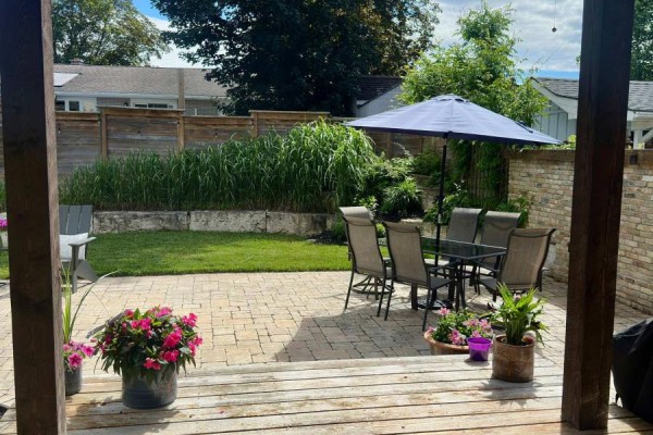 Backyard with patio area, snow patches, and garden beds - 241 4th Street Crescent, Hanover
