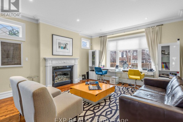 Open living space with a view of the dining area, stylish furniture, and hardwood flooring. - 241 Poplar Plains Street, Toronto