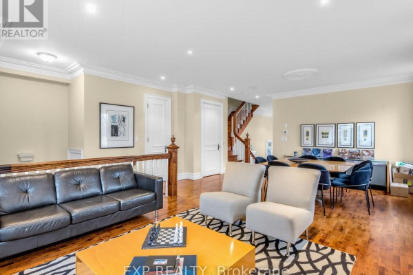 Staircase leading to the upper level, with a view of the dining area and large artwork. - 241 Poplar Plains Street, Toronto