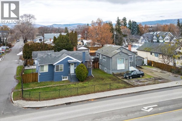 Front exterior view of two houses on 2415 Pandosy Street, with one painted blue and the other grey. - 2415 Pandosy Street, Kelowna