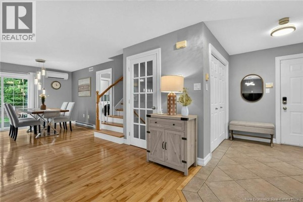 Open concept living and dining area with grey walls and hardwood floors. - 242 Doreen Crescent, Dieppe