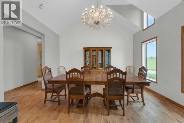 Entryway with light grey walls, a white door, grey tiled floor, and built-in oak cabinets. - 242017 Township Road 232, Rural Wheatland County