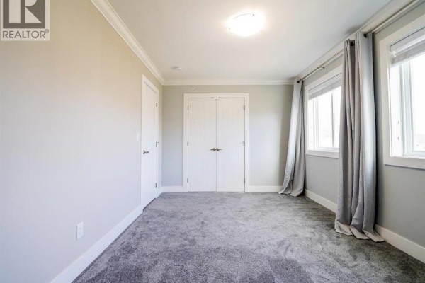 Empty room with light gray walls, laminate flooring, and window - 24302 101a Avenue, Maple Ridge