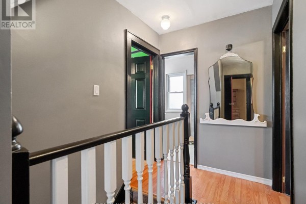 Dining room with wooden furniture, hutch, and terrarium - 244 North Street Fort Erie