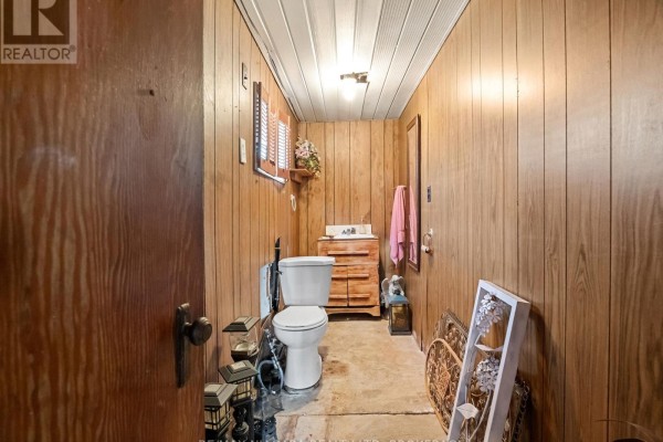 Bedroom with green/brown walls, whiteboard, and covered furniture - 244 North Street Fort Erie
