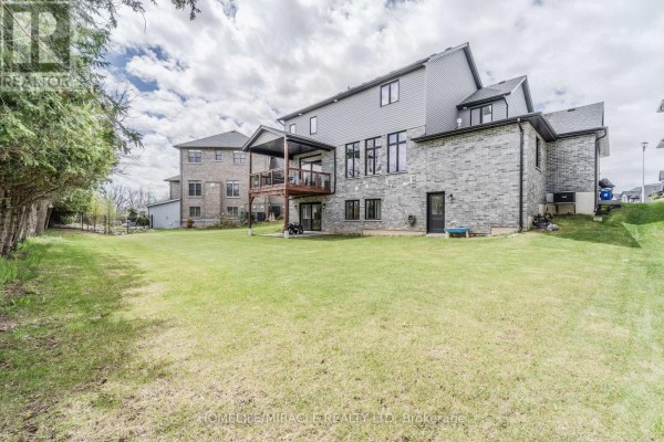 Backyard with deck and grass lawn - 245 Tamarack Boulevard Woodstock