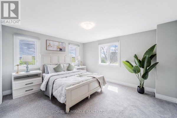 Bedroom with king-size bed and nightstands - 245 Tamarack Boulevard Woodstock