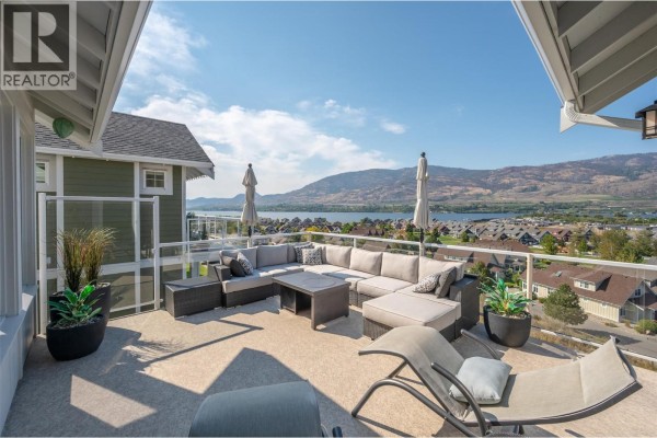 Outdoor terrace with sectional seating, overlooking a lake and mountains - 2450 Radio Tower Road Unit# 174, Oliver