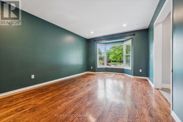 Interior foyer with white door, stained glass sidelights, and grey walls. - 2456 Sixth Line, Oakville