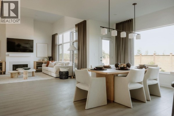 Open concept living and dining area with large windows and neutral decor. - 2464 Alder Way, Tsawwassen