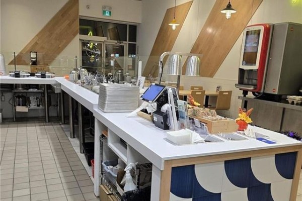 Service counter with utensils, napkins, and a red beverage dispenser. - 2465 Appleby Line Unit# D1-b, Burlington