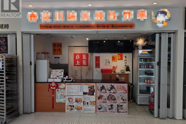 Small food stall with a counter, menu displays, and a refrigerator behind closed metal shutters. - 247 - 7181 Yonge Street, Markham