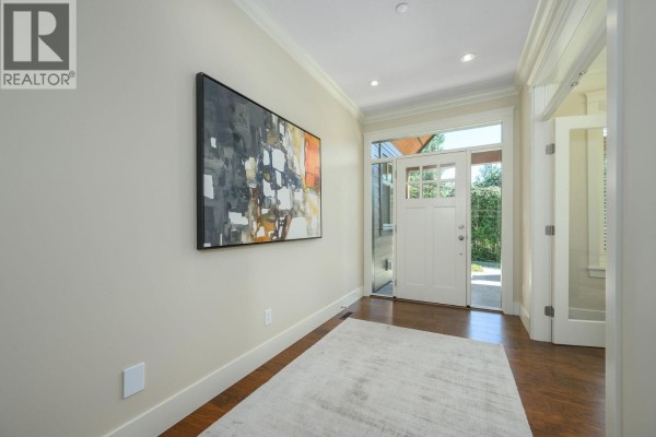 Interior foyer with hardwood floors, beige walls, a large abstract painting, and front door. - 2475 Leggett Drive, Port Moody