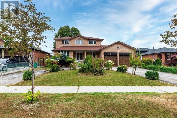 Front view of a two-story brick house with a manicured lawn and sidewalk. - 2477 Cliff Road, Mississauga