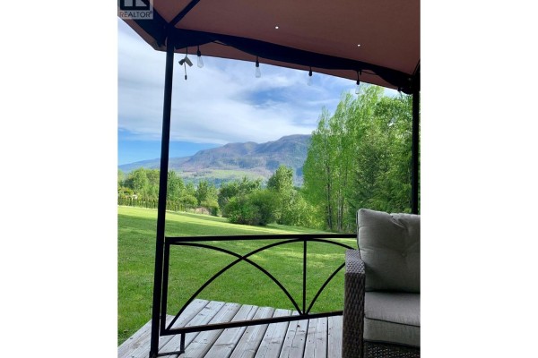 Covered patio view overlooking green lawn and mountains in the distance - 2481 Squilax-anglemont Road Lot# 11, Lee Creek