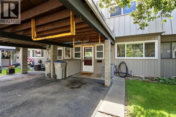 Interior entryway with front door, window, tiled floor, and staircase. - 249 Kitchener Crescent Unit# 5, Kamloops