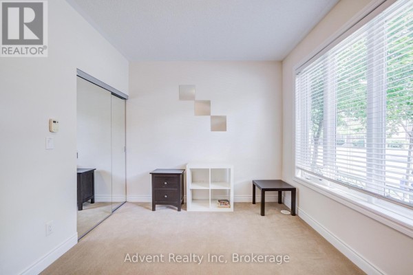 Room with a mirrored closet, white cube shelf, dark dresser, and window. - 249 South Park Road, Markham