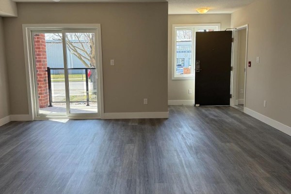 Interior view showing a living area with a sliding glass door and a hallway. - 25 Alexandria Avenue, St  Thomas