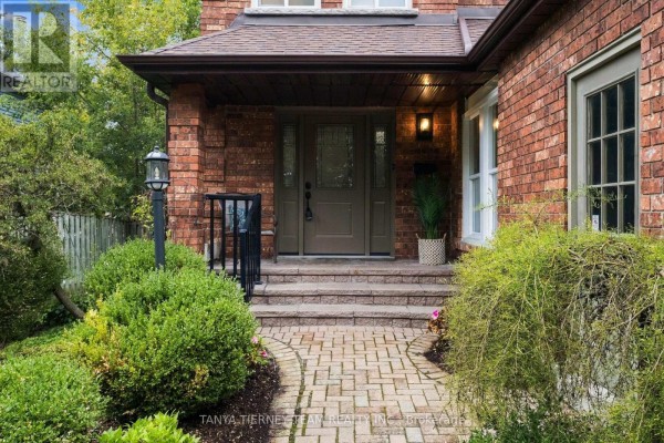Close-up of the house entrance with a brick walkway, stone steps, and a covered porch. - 25 Coulton Court, Whitby