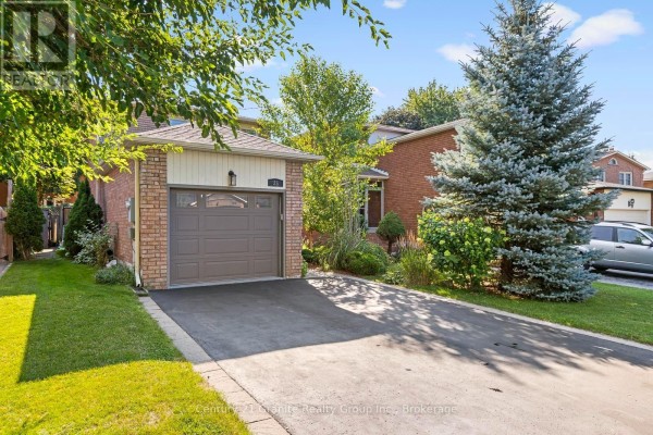 Close-up of the garage door and brick facade of the house on a sunny day. - 25 Greenwood Road, Whitchurch Stouffville