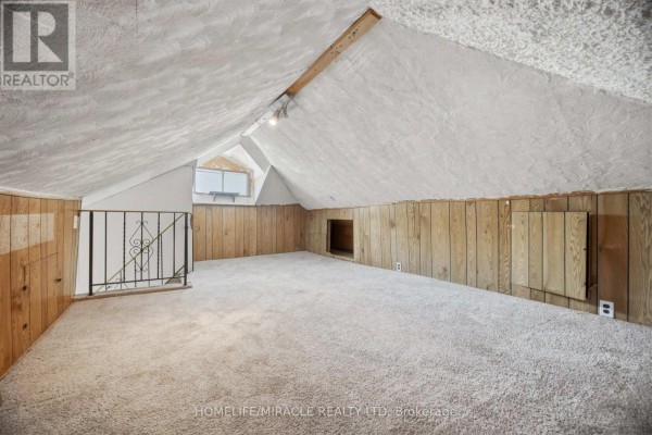 Attic room with vaulted ceiling, wood paneling, and carpet - 25 Hope Avenue Hamilton
