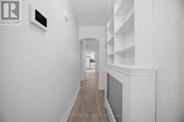 Hallway with built-in shelving and archway to kitchen - 25 Hope Avenue Hamilton