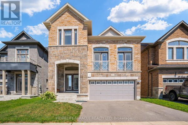 Exterior of a modern two-story house with stone and brick detailing. - 25 Lorne Thomas Place, New Tecumseth