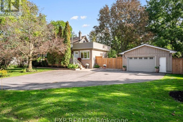 Exterior view of the residential property showing the house, driveway, and detached garage. - 25 Morton Avenue, East Gwillimbury