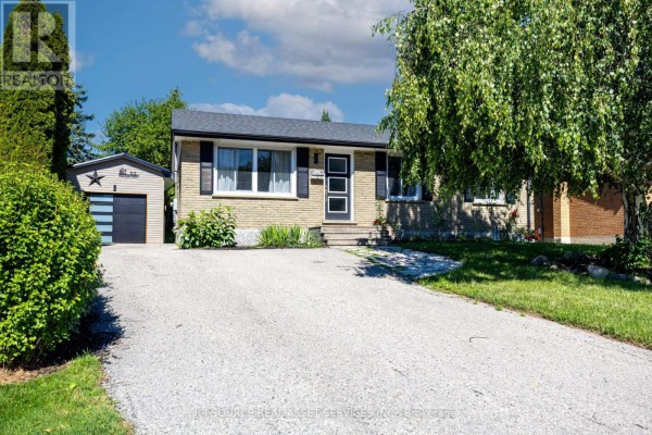 Exterior view of a brick bungalow with a paved driveway and single-car garage. - 25 Paulson Court, St  Thomas