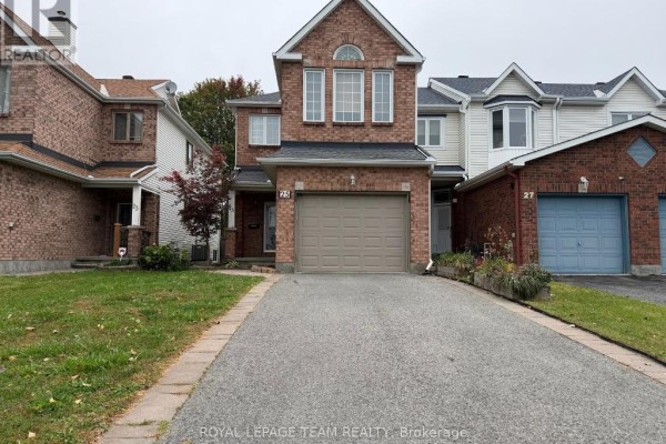 Exterior view of 25 Redpath Drive, a red brick townhouse with an attached garage and driveway. - 25 Redpath Drive, Ottawa