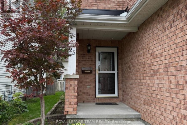 Close-up of the covered front entrance with brick pillars, a glass door, and a mailbox. - 25 Redpath Drive, Ottawa