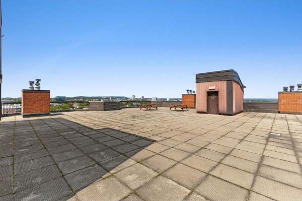 Rooftop terrace with concrete tiles, picnic tables, and city view. - 25 Rue Victoria, #501, Gatineau