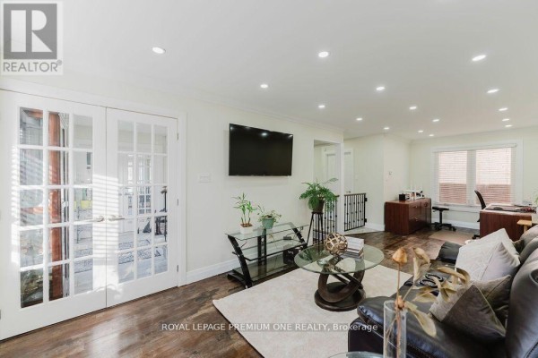 Interior view of the foyer with a wooden staircase and tile flooring. - 25 Sir Lancelot Court, Caledon