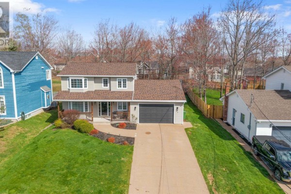 Aerial view of a beige two-storey house, blue house, and neighbourhood. - 25 Terrace Heights Drive, New Glasgow