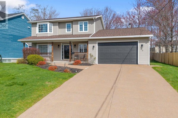 Front view of a beige house with a driveway and attached garage. - 25 Terrace Heights Drive, New Glasgow