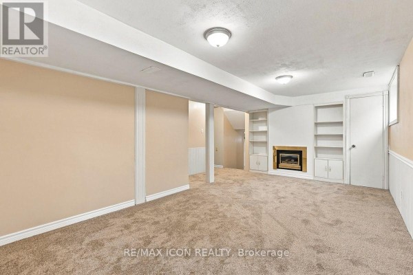 Finished basement with fireplace and built-in bookshelves - 25 Upcott Crescent London South