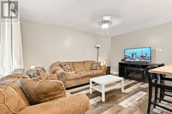 Living room with two couches, a coffee table, and a television on a media unit. - 25 Upcott Crescent, London South